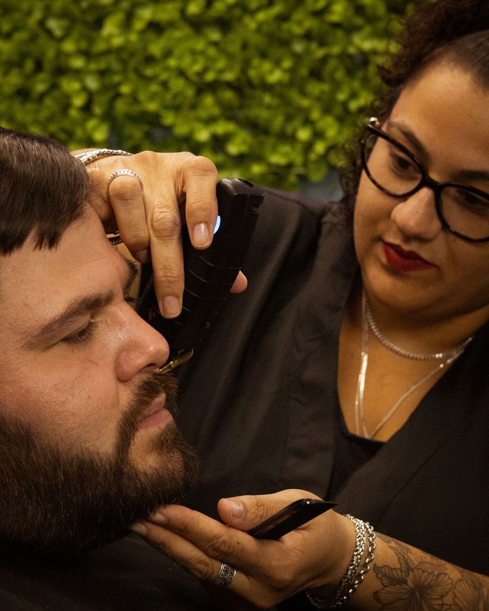 Professional haircut session showing detailed grooming technique in a barbershop.