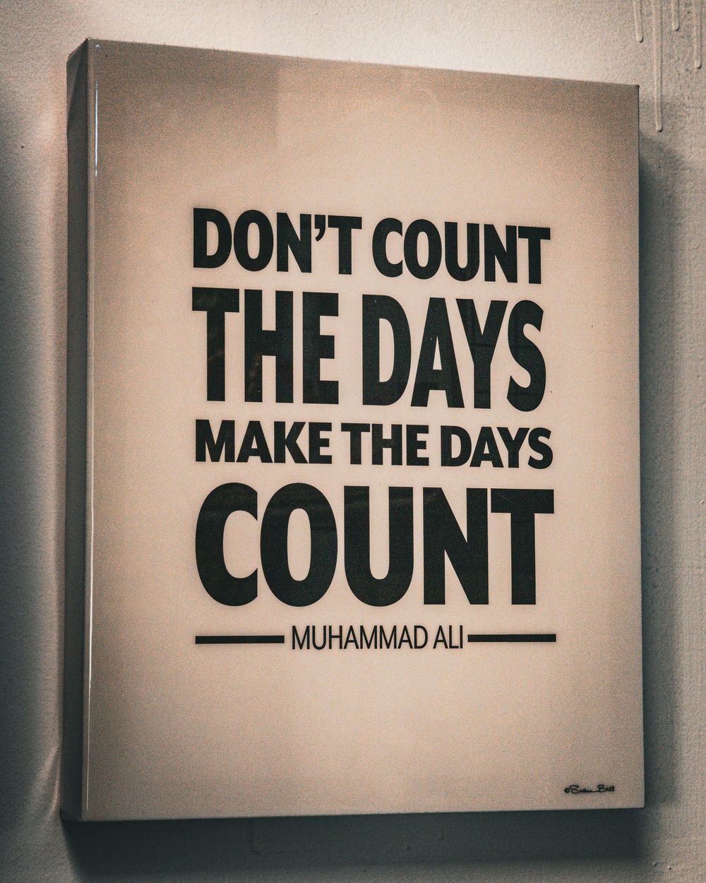 Motivational quote by Muhammad Ali on canvas about making days count.