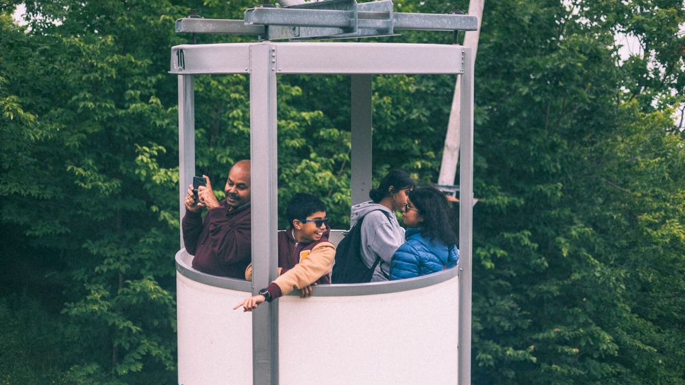 Cable car gondolas transport visitors up a scenic mountainside route.