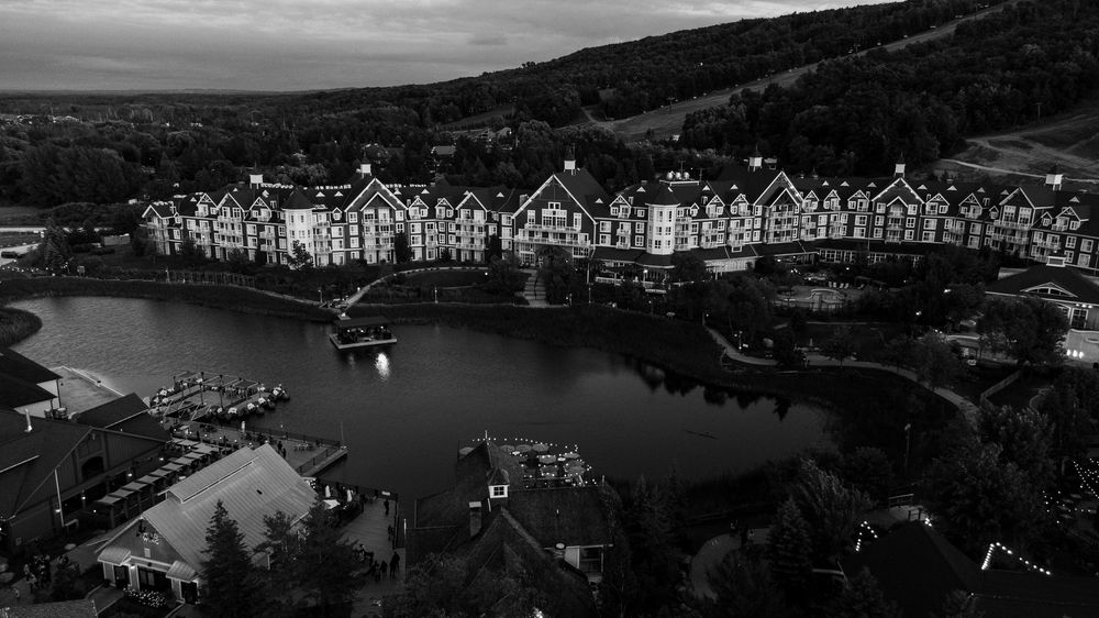 Black and white panoramic cityscape showing waterfront buildings.