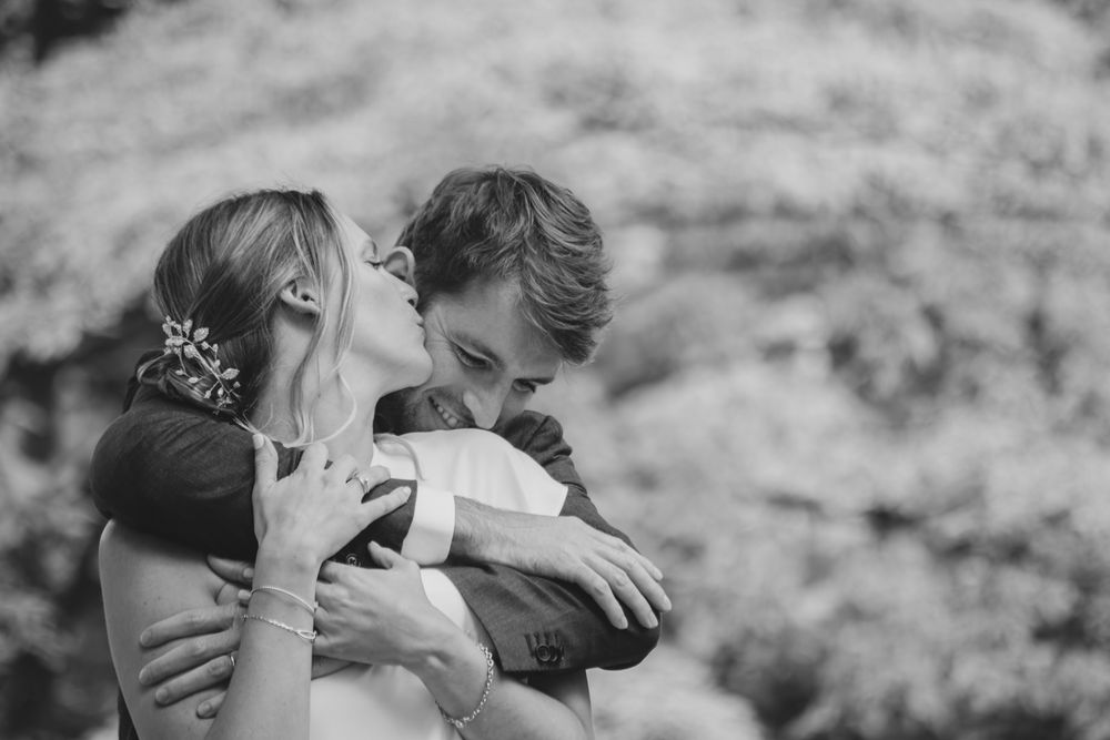 Intimate black and white wedding portraits showing tender embraces.