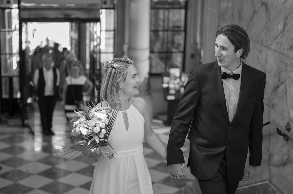 Classic black and white wedding photos captured in an elegant indoor venue.