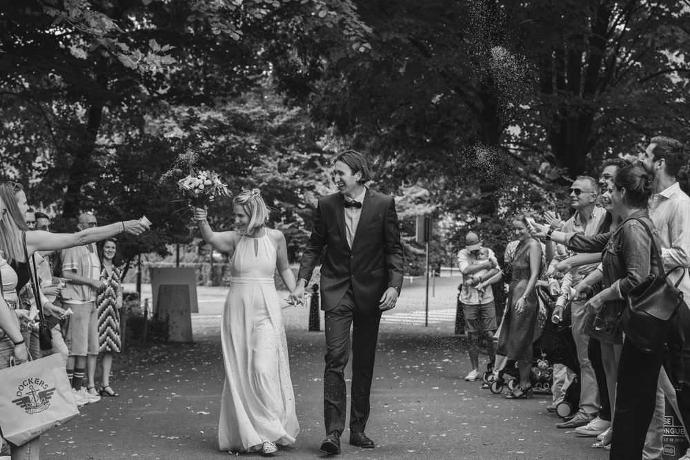 Wedding ceremony outdoors with a couple dancing joyfully in a garden setting.