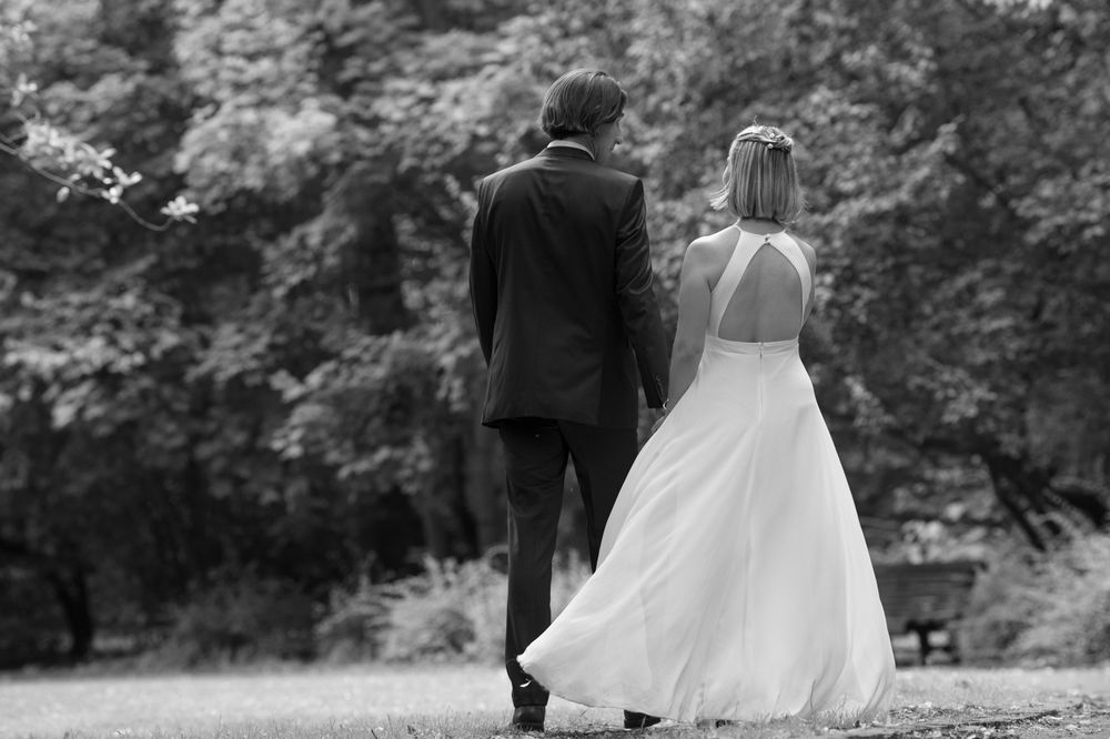Couple sharing an intimate dance moment in a lush garden setting.