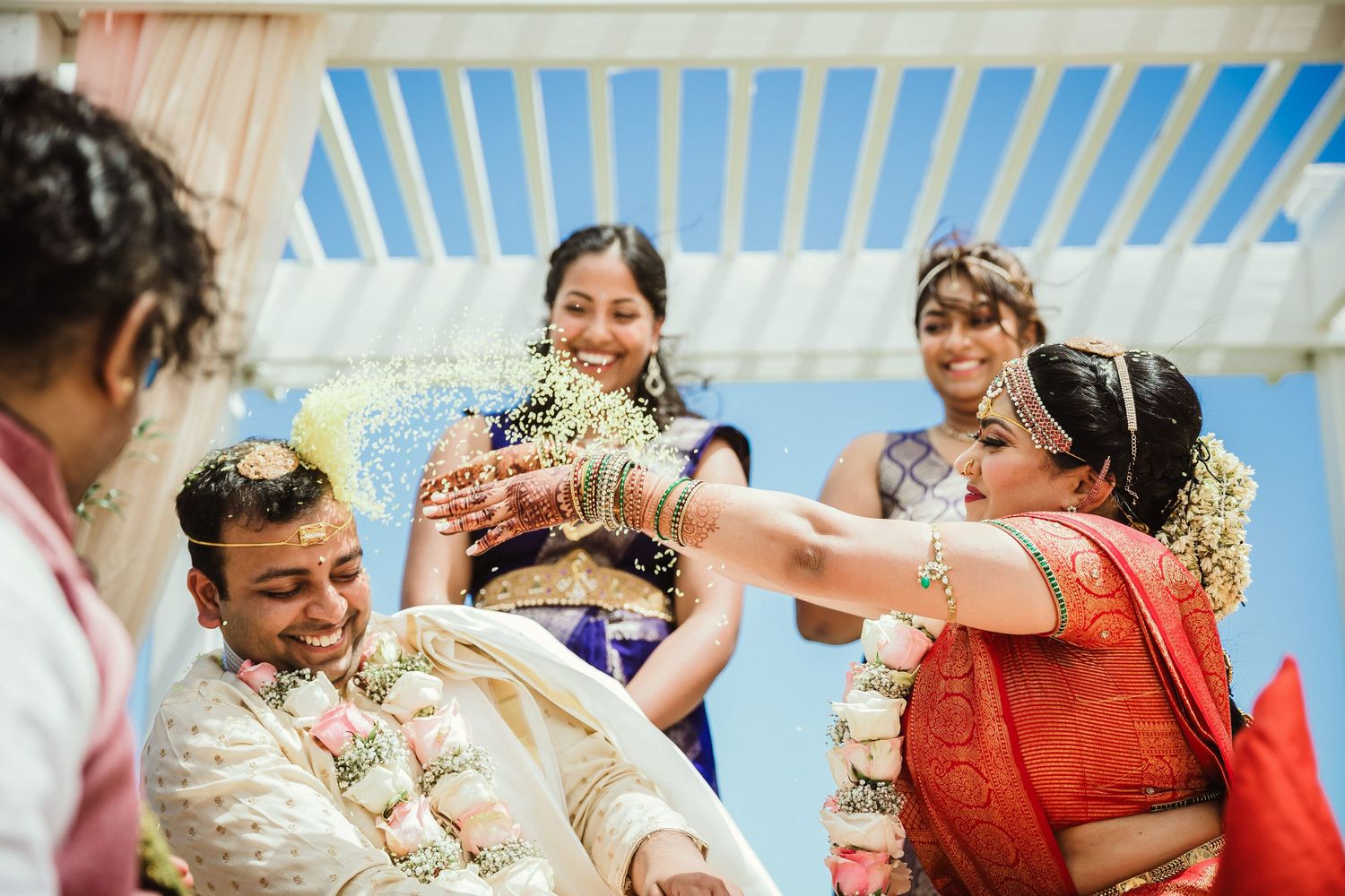 Celebratory moment during a traditional Indian wedding ceremony with colorful attire.