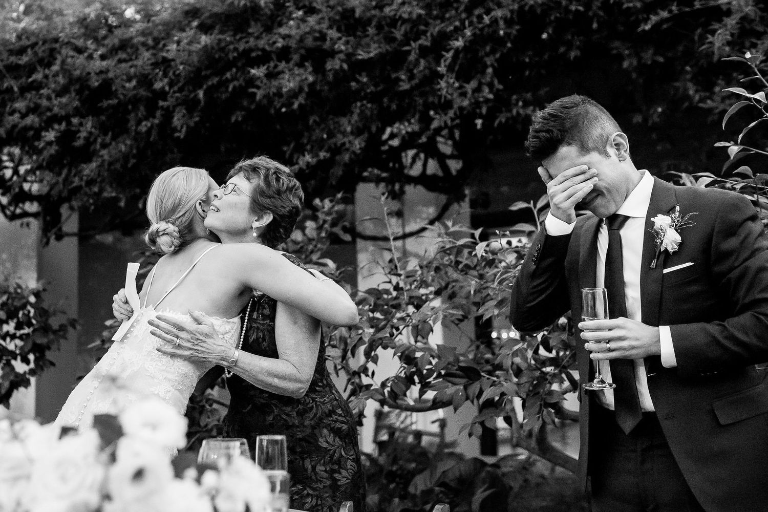 A collection of black and white wedding photos showing intimate moments between couples during their celebrations.