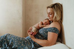 Tender moments captured in soft natural light against neutral walls.