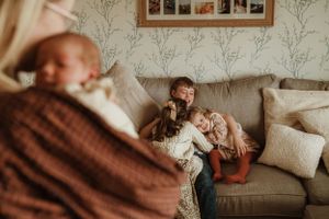 Interior home scene with family photos and comfortable seating arrangements.