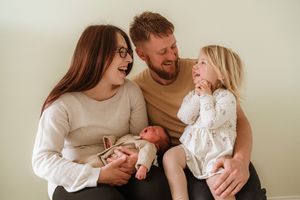 Candid family moment captured during indoor photo session.