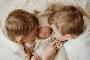 Intimate close-up shots of a newborn baby with soft lighting and delicate details.