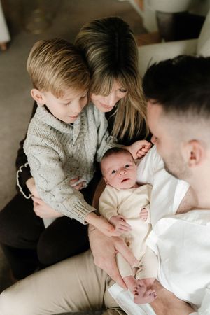 A tender family moment captured in a series of intimate black and white photographs showing gentle interaction and connection.