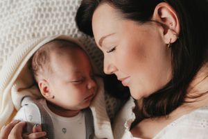 A tender moment between a mother and newborn baby captured in a series of black and white photographs.
