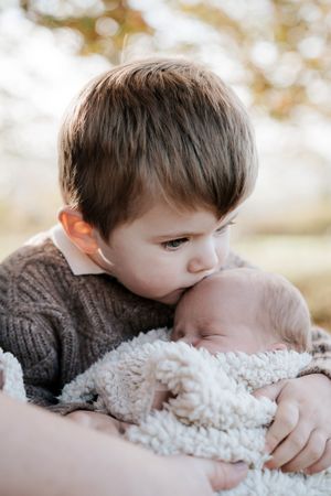 A sequence of tender moments showing a young child snuggling with a fluffy white teddy bear against a soft blurred background.
