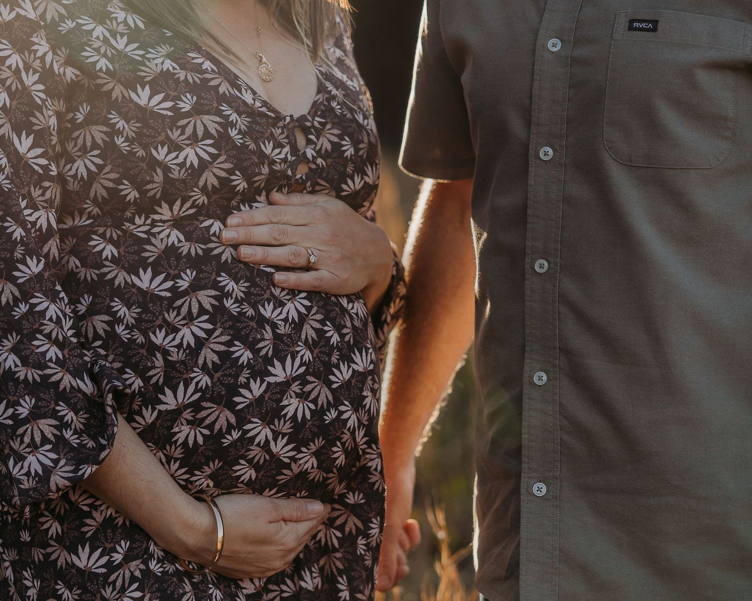NSW South Coast Maternity photography – woman and man standing close together holding pregnant belly