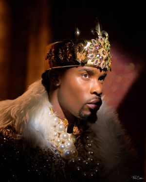 Regal portrait featuring an ornate jeweled crown and luxurious fur-trimmed collar against a dark background.