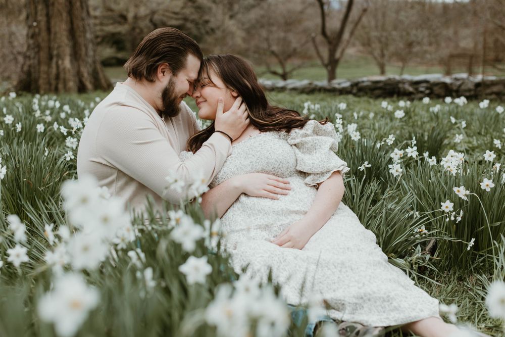 Intimate family moment captured in a field of blooming spring flowers.