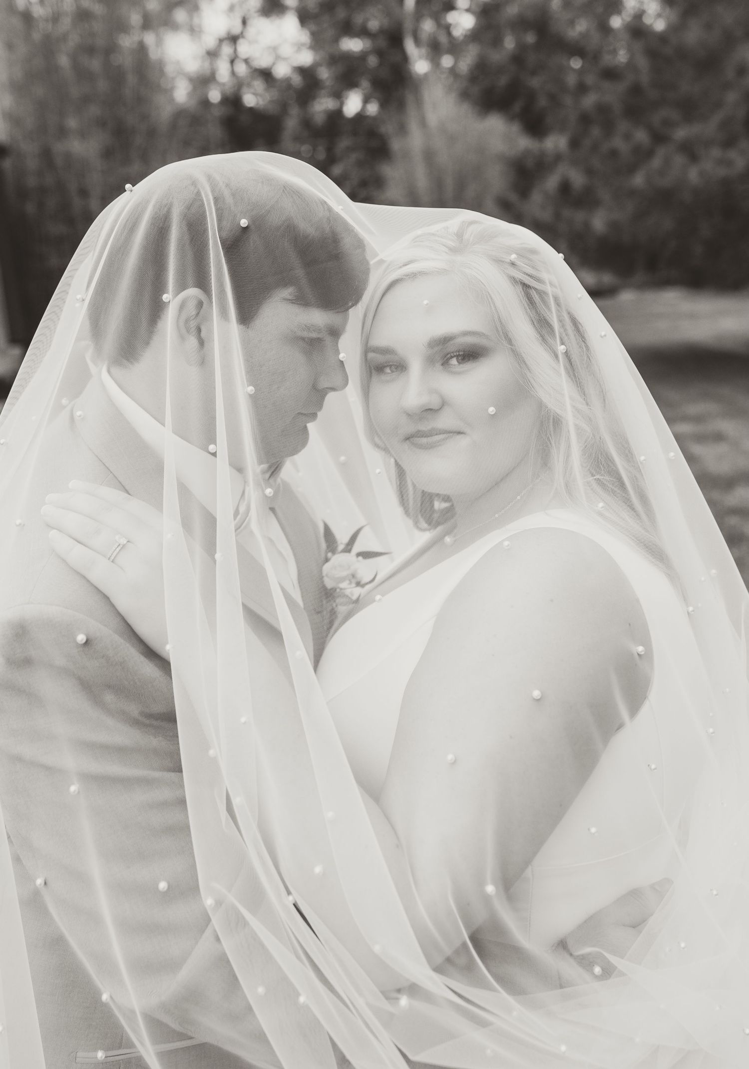 A dreamy black and white wedding portrait sequence showing a bride with flowing veil in romantic outdoor setting.