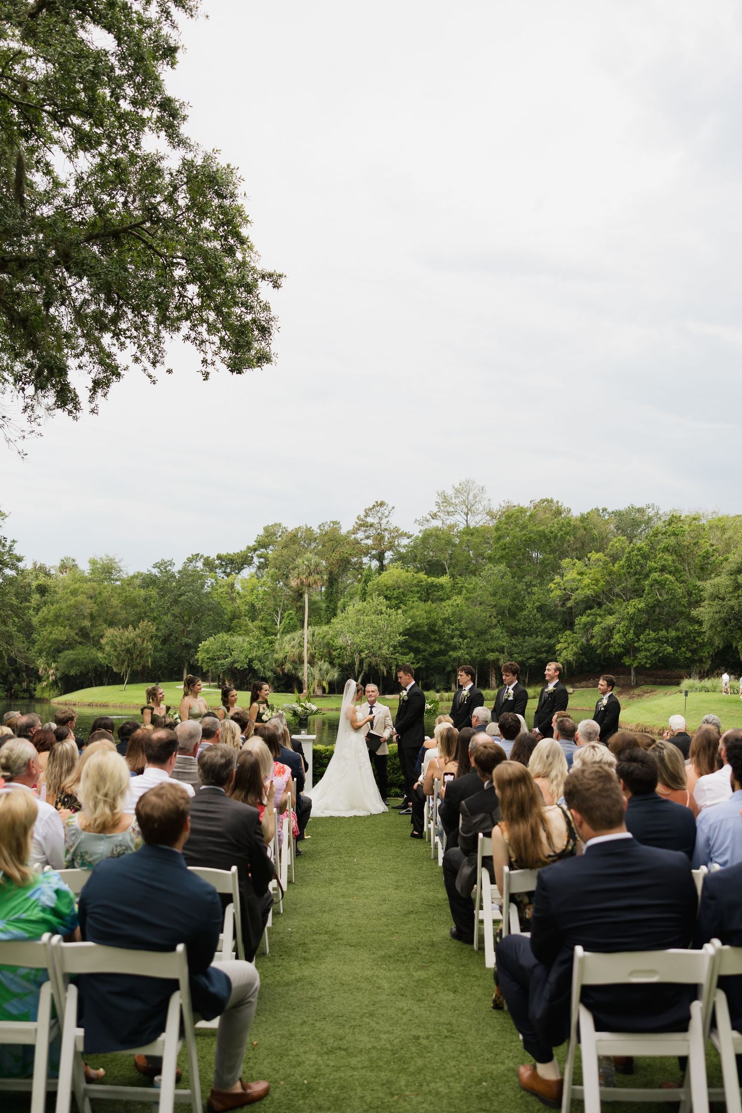 Close-up of a bride and groom, eyes closed and smiling as they lean in, capturing an intimate and joyful wedding day moment.