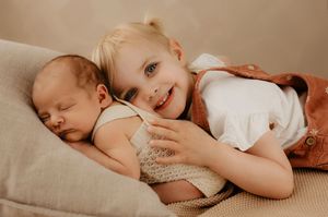 Intimate family photography session with soft neutral backdrop.