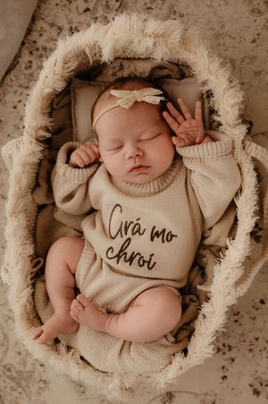 Series of newborn portraits in cozy cream-colored nest with different text overlays.