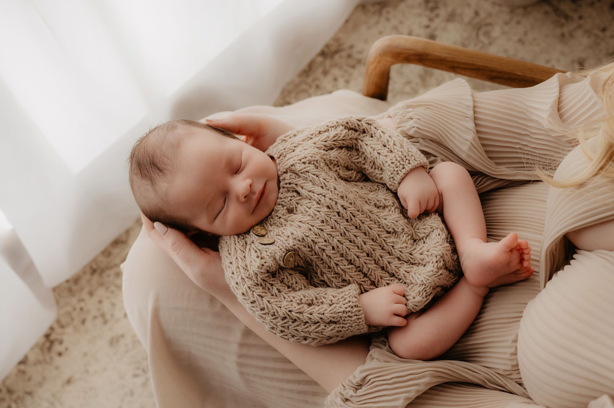 A series of connected images showing a newborn baby's tiny feet wearing a cozy knit bootie against a neutral background.