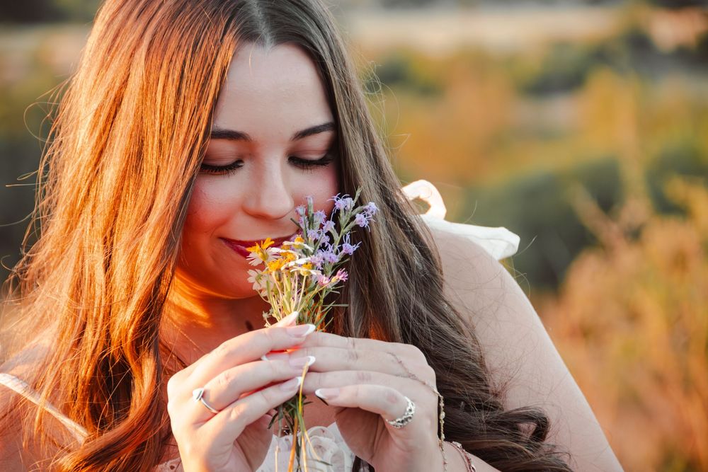 High school senior portrait with wildflowers during golden hour in the Texas Hill Country