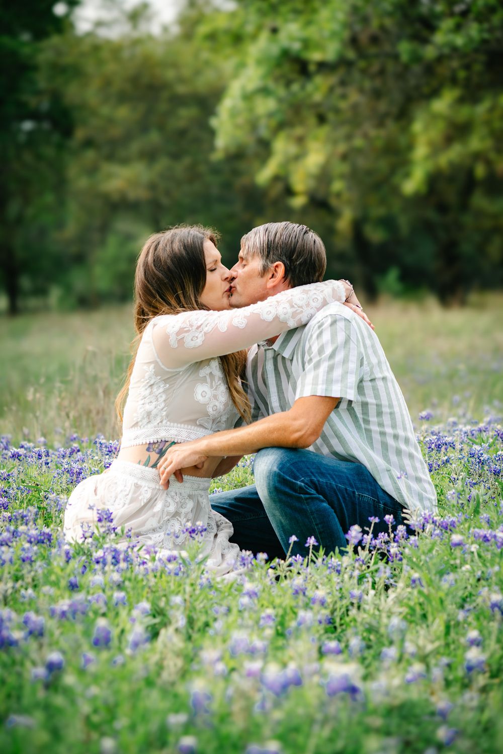 Couple embracing in a field of bluebonnets near San Antonio, Texas