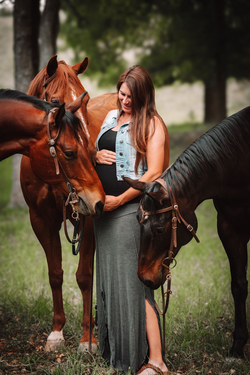 Woman sharing a quiet moment with her horses during a equine maternity session in Boerne, Texas