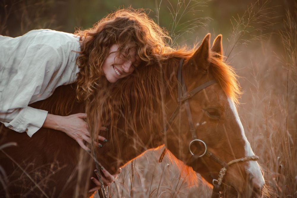 Woman embracing her horse during a golden hour equine portrait session in Boerne, Texas