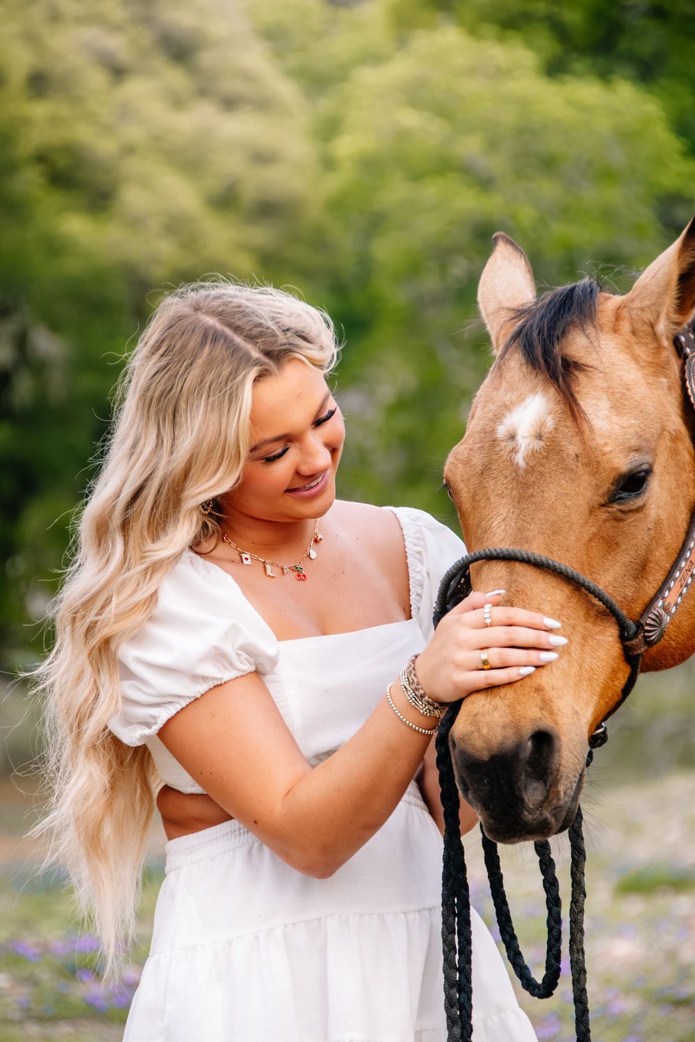 High school senior with her horse during an equine senior portrait session in Boerne, Texas