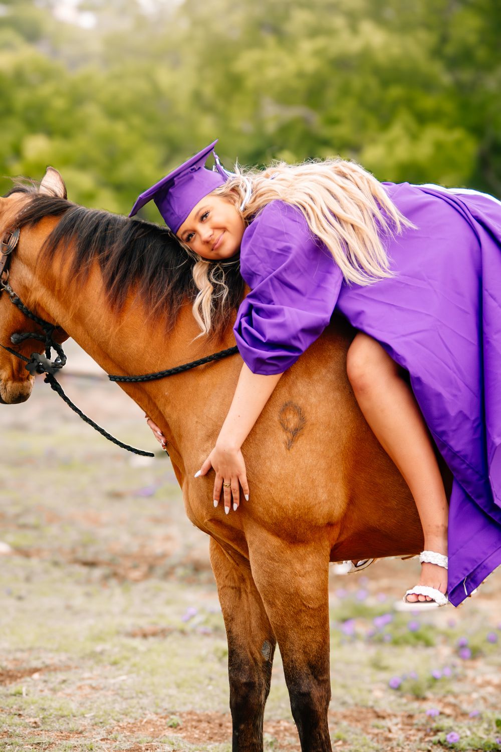 High school senior in cap and gown with her horse near San Antonio, Texas