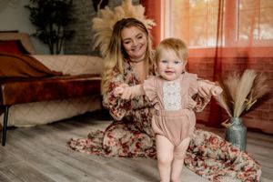 Cozy indoor lifestyle portrait with warm lighting and boho decor elements.
