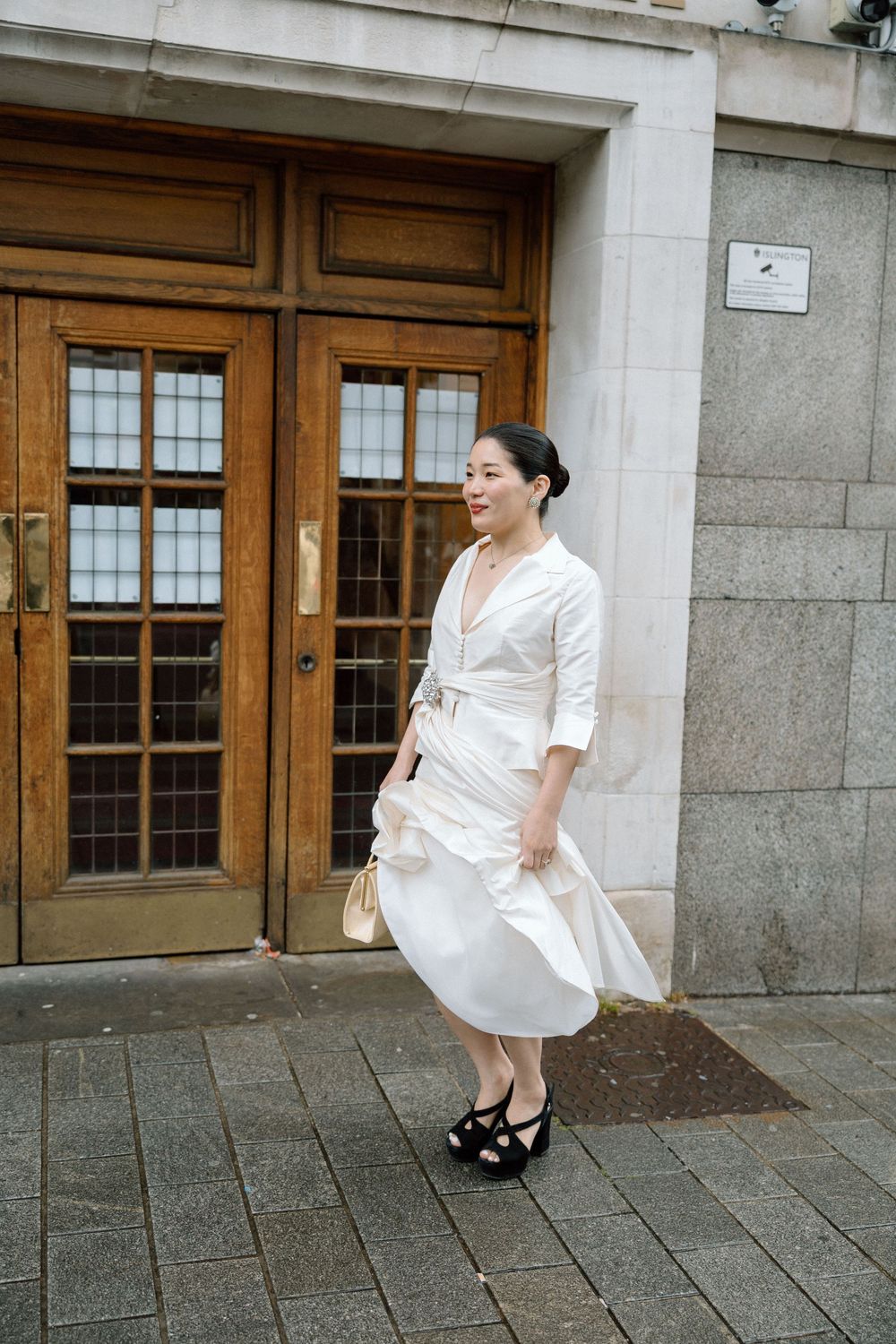 Bride waits outside Islington Town Hall, London.