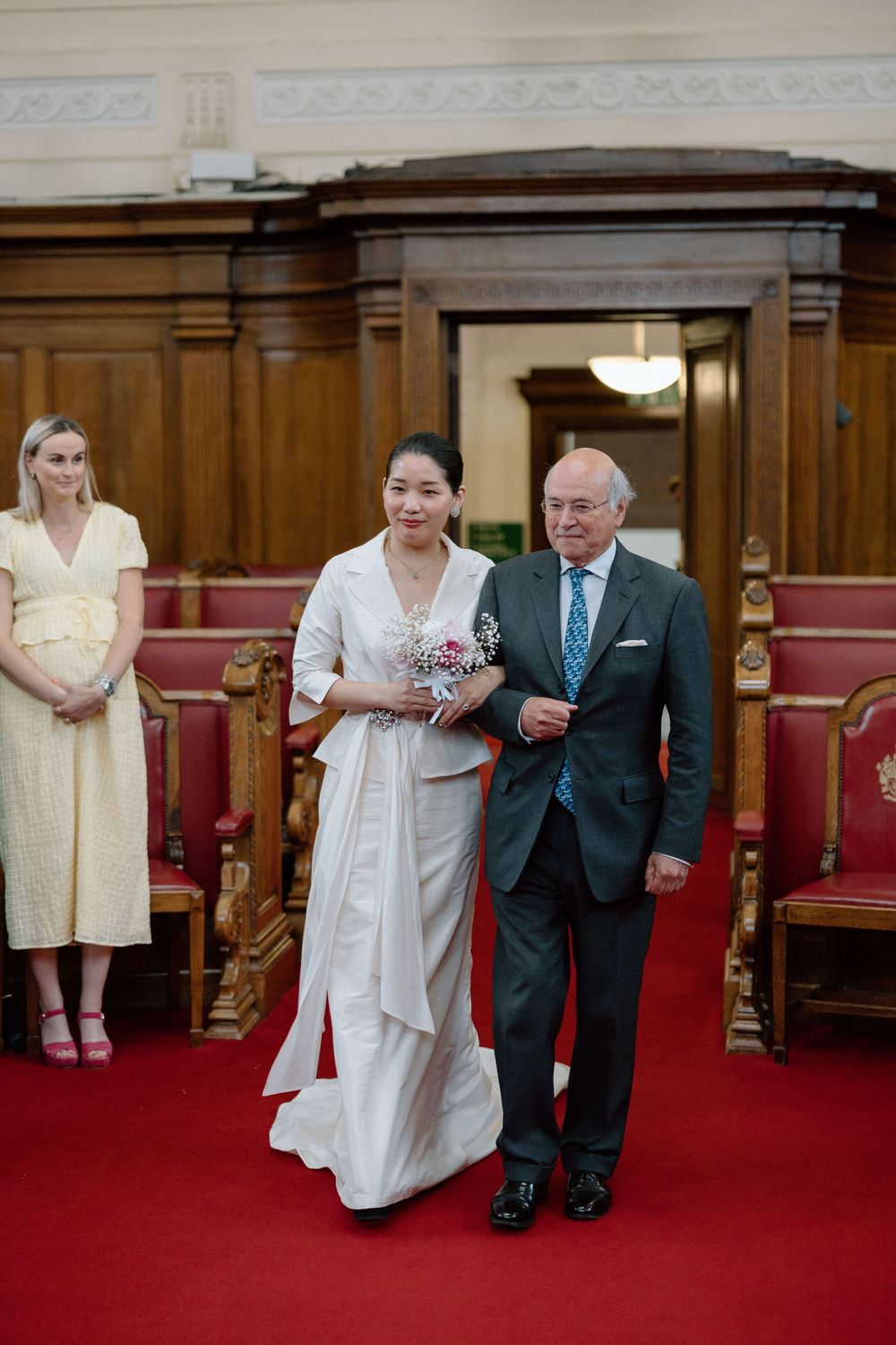Bride walks down the aisle at Islington Town Hall.