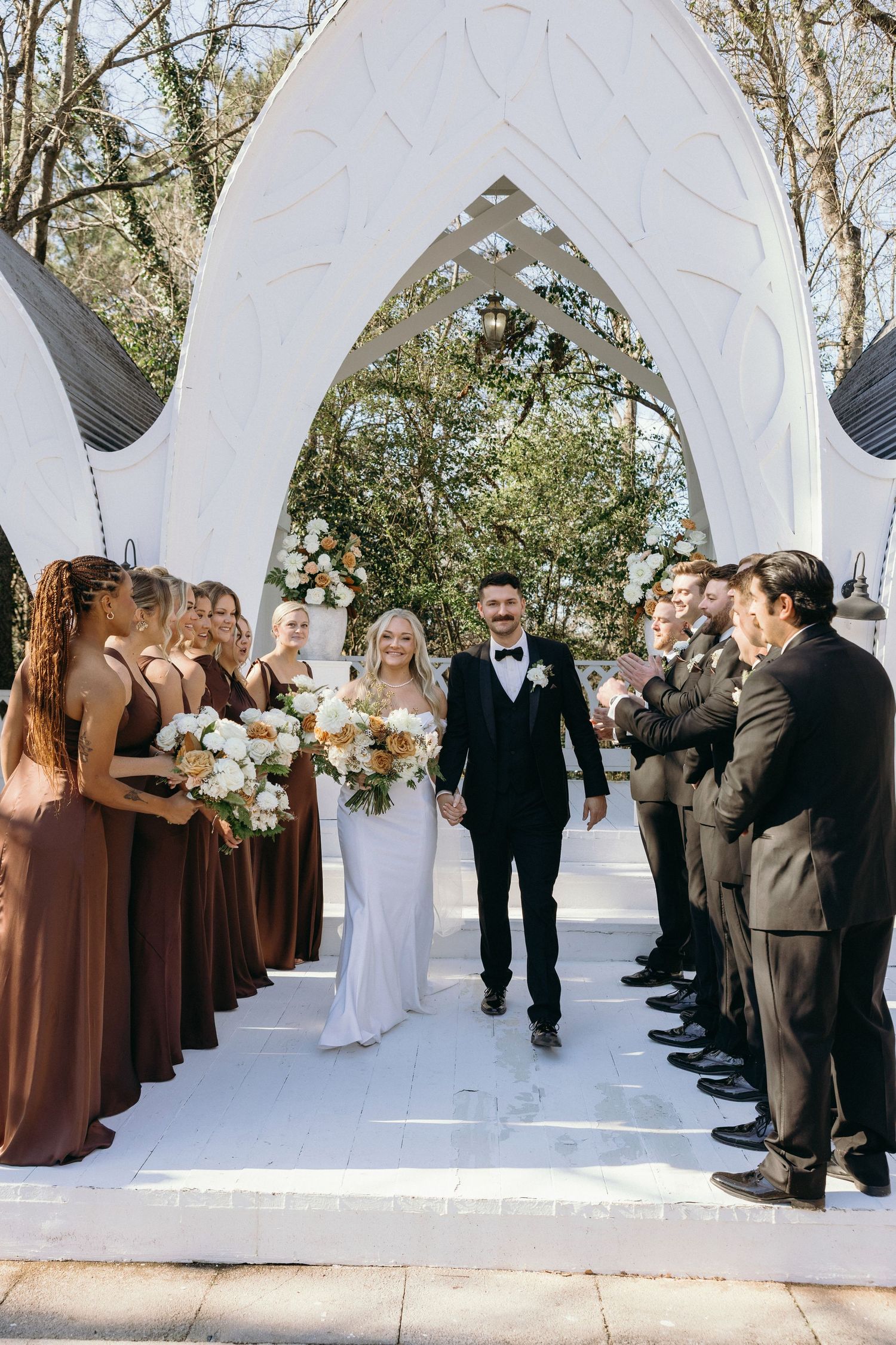 Bride and groom walk down aisle at the garden wedding venue, The wildflower 301.