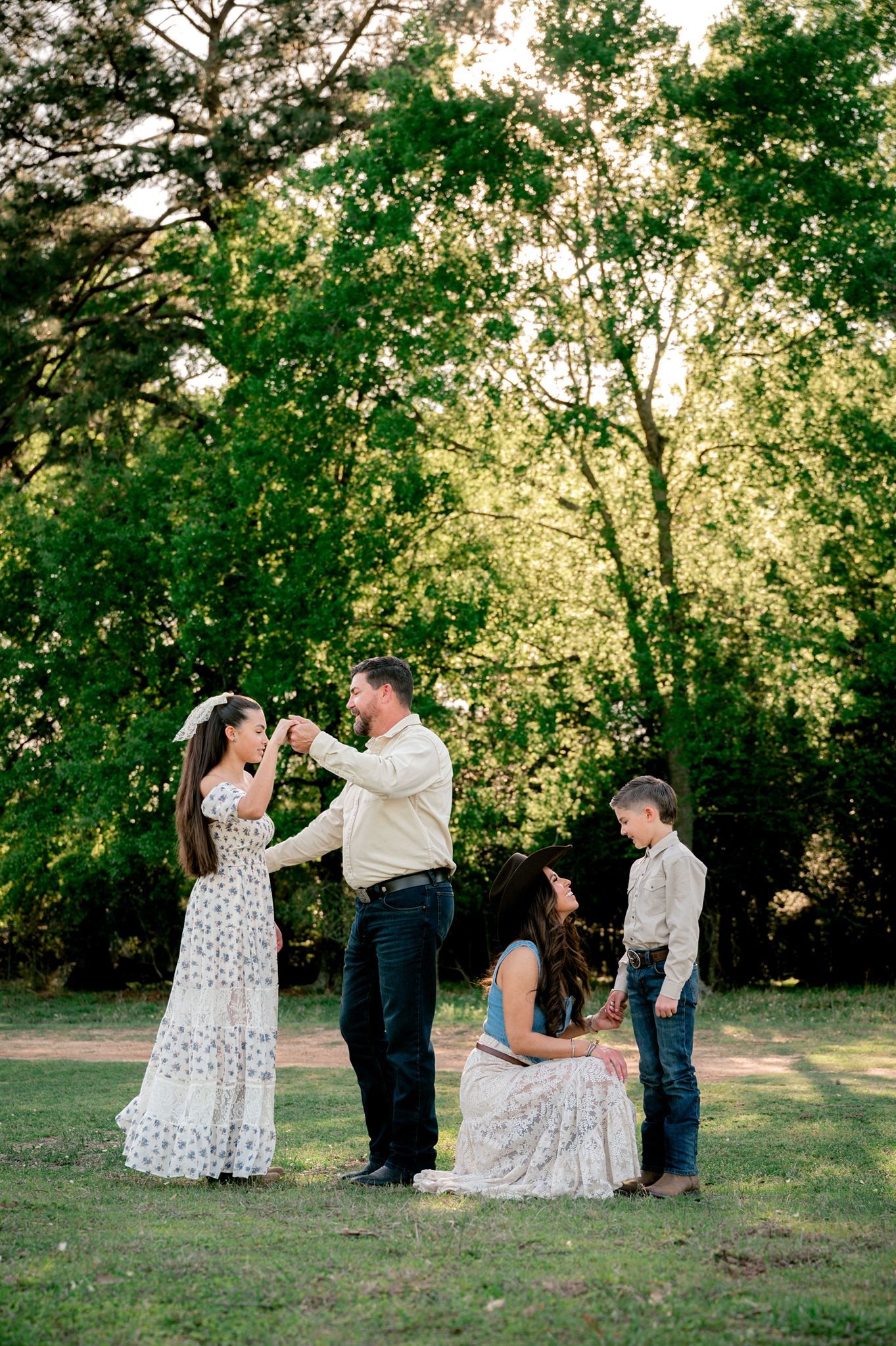 Mother crouching beside her young son for a sweet, natural moment during their Tomball family photography session.