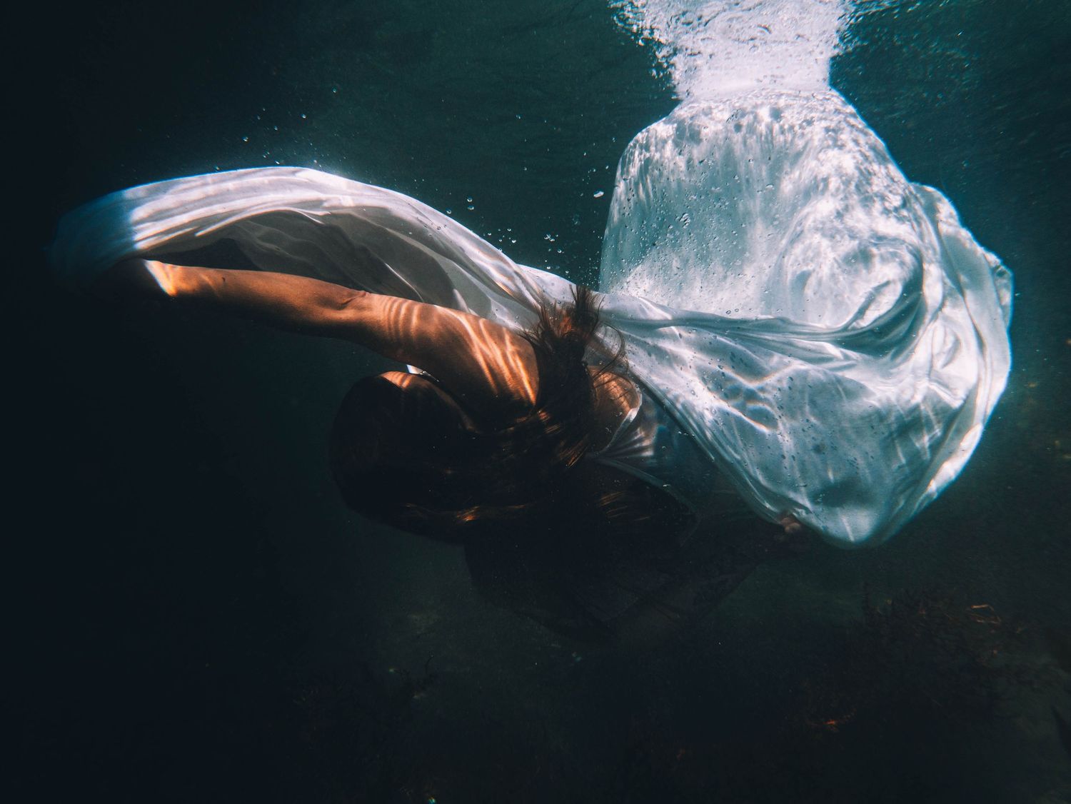 underwater portrait of a woman in playful bright light at Lake Macquarie NSW