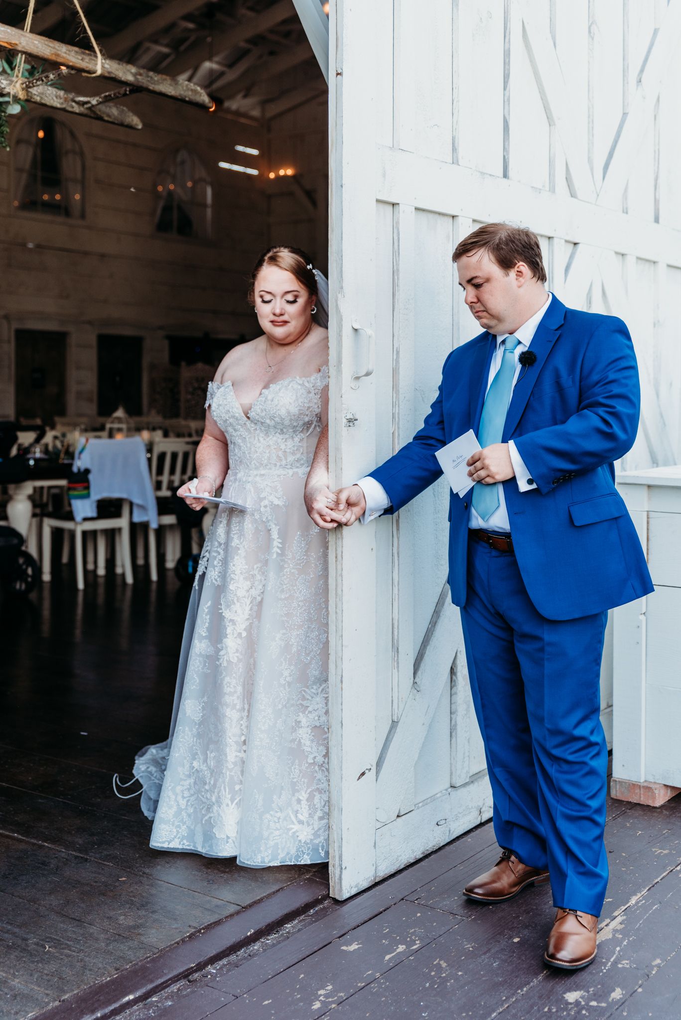 Bride and groom share a first touch and private vow exchange at The White Barn at Lucas Farms in Maryland.