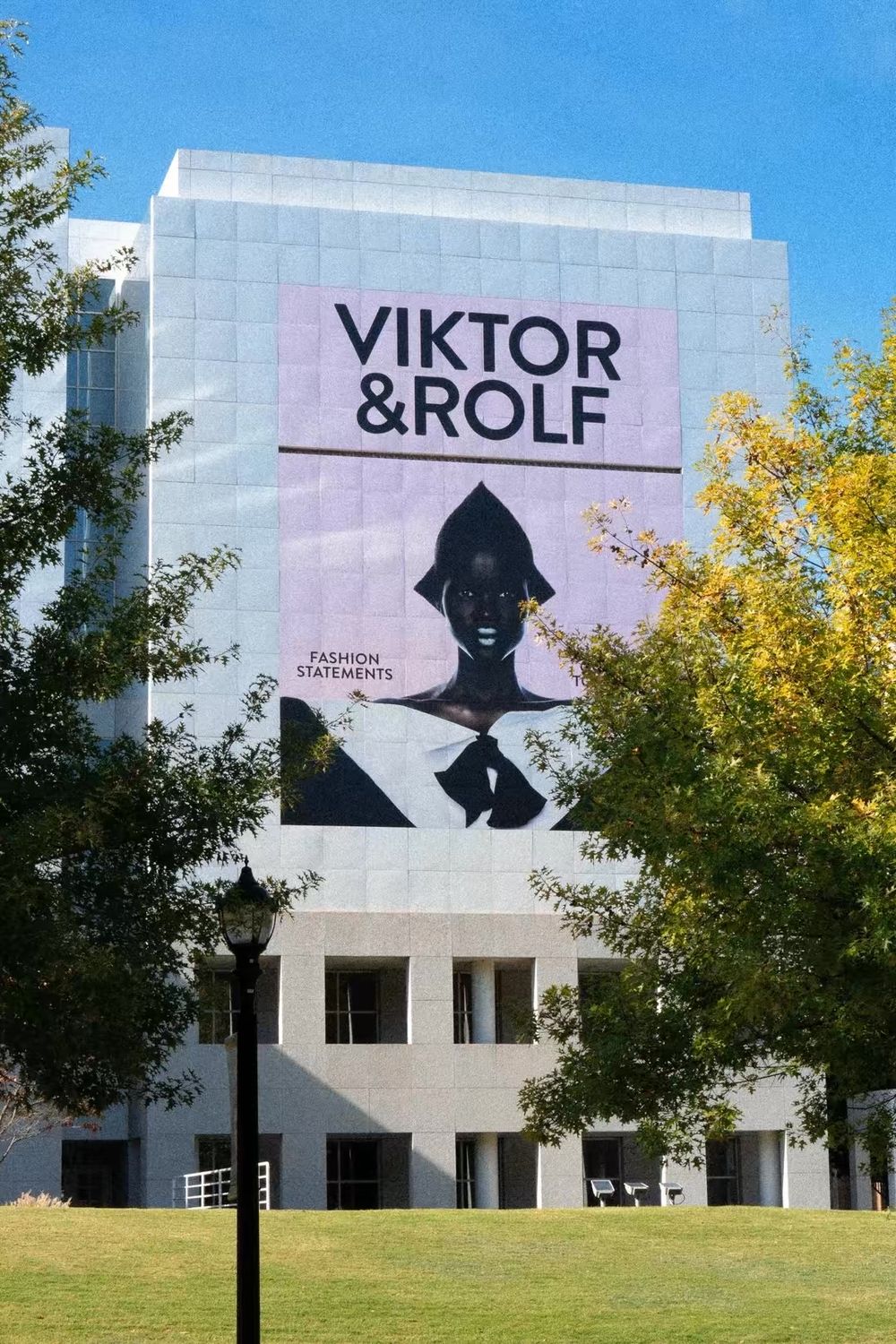 Large Viktor and Rolf Fashion Statements exhibition banner displayed on a gray museum building.