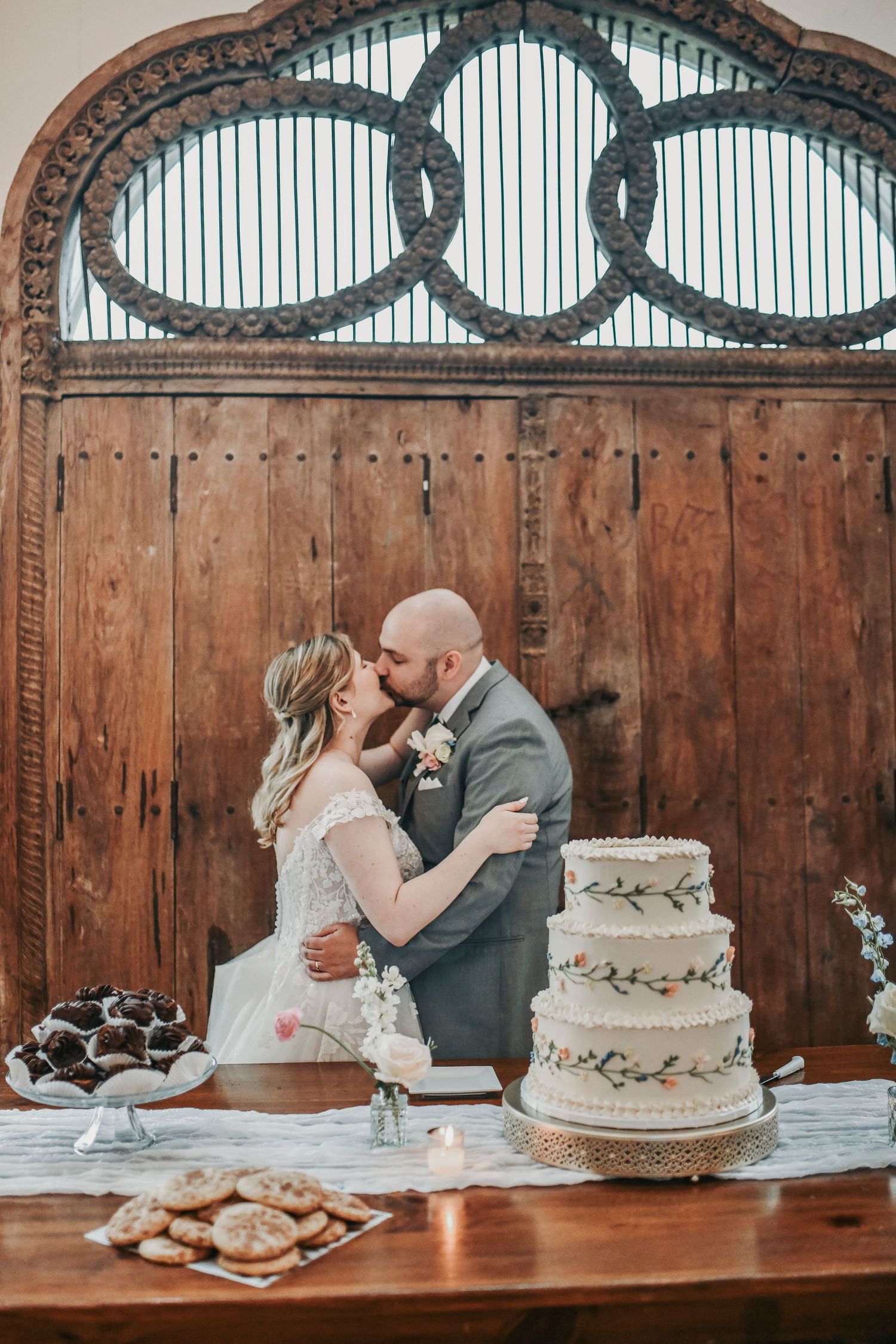 Newlyweds laughing together during their wedding cake cutting