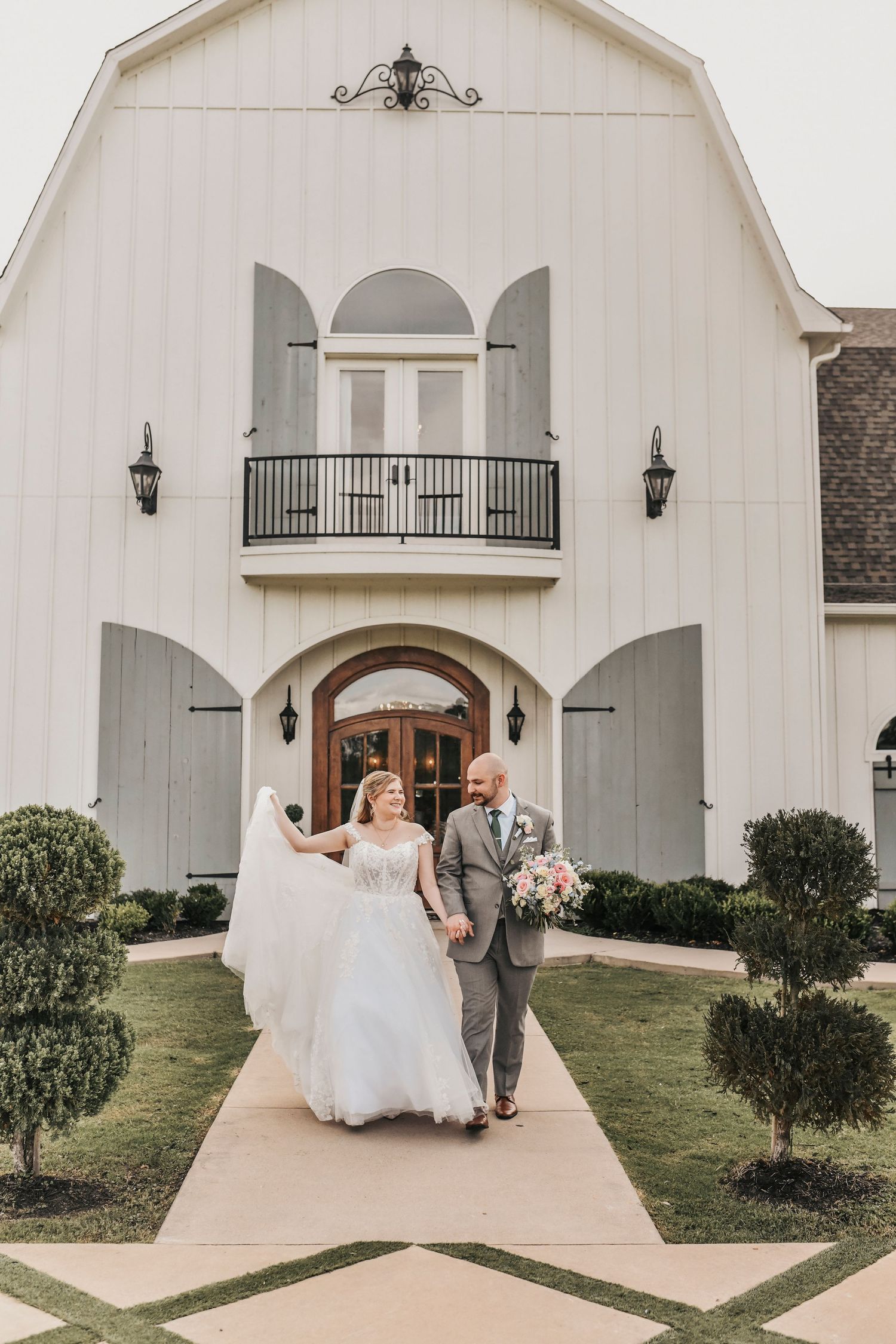 Bride surrounded by her bridal party outside The French Farmhouse