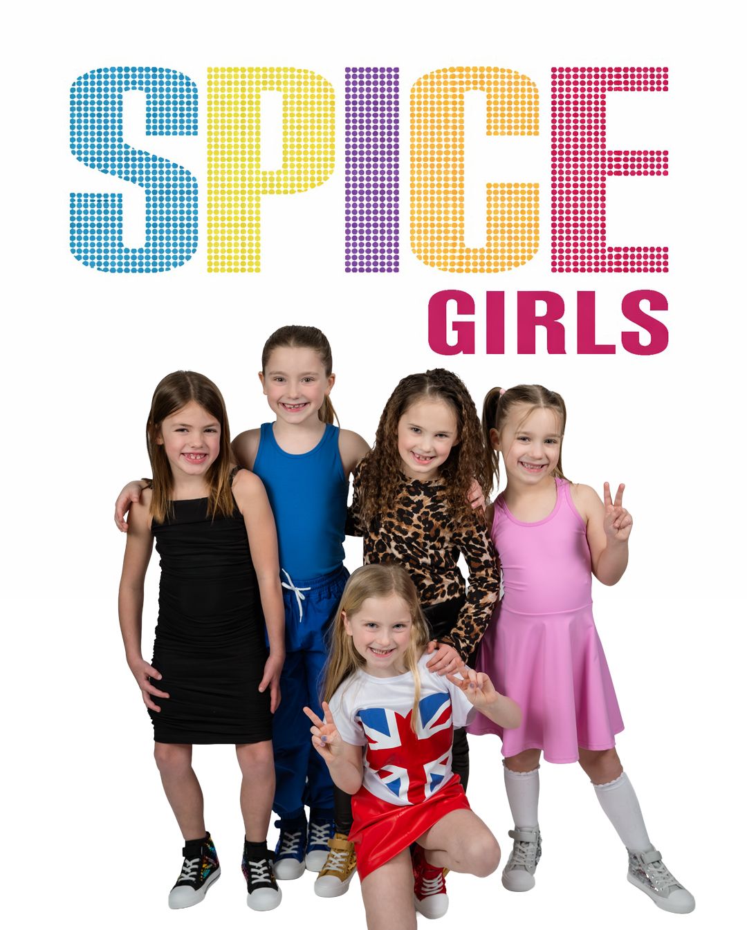 Five young girls dressed as the Spice Girls pose together under a colorful Spice Girls logo on white background.