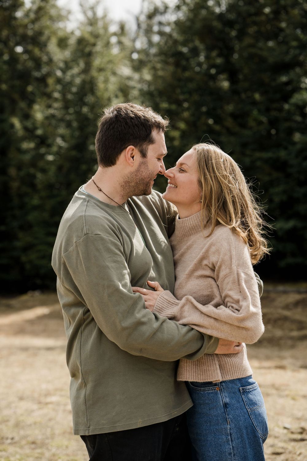 Couple standing cuddling and laughing