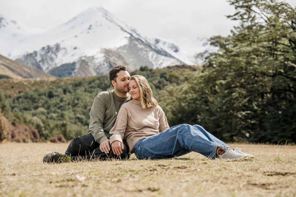 Couple sitting cuddling at Castle Hill, New Zealand
