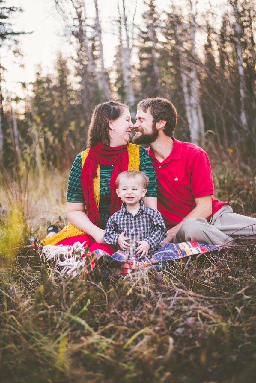 Family sitting together in a field during an outdoor family photography session