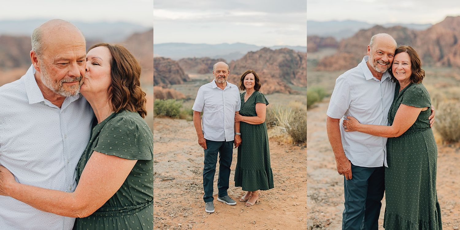 Couple embracing in desert landscape, woman in green dress kissing mans cheek, red rock formations in background.