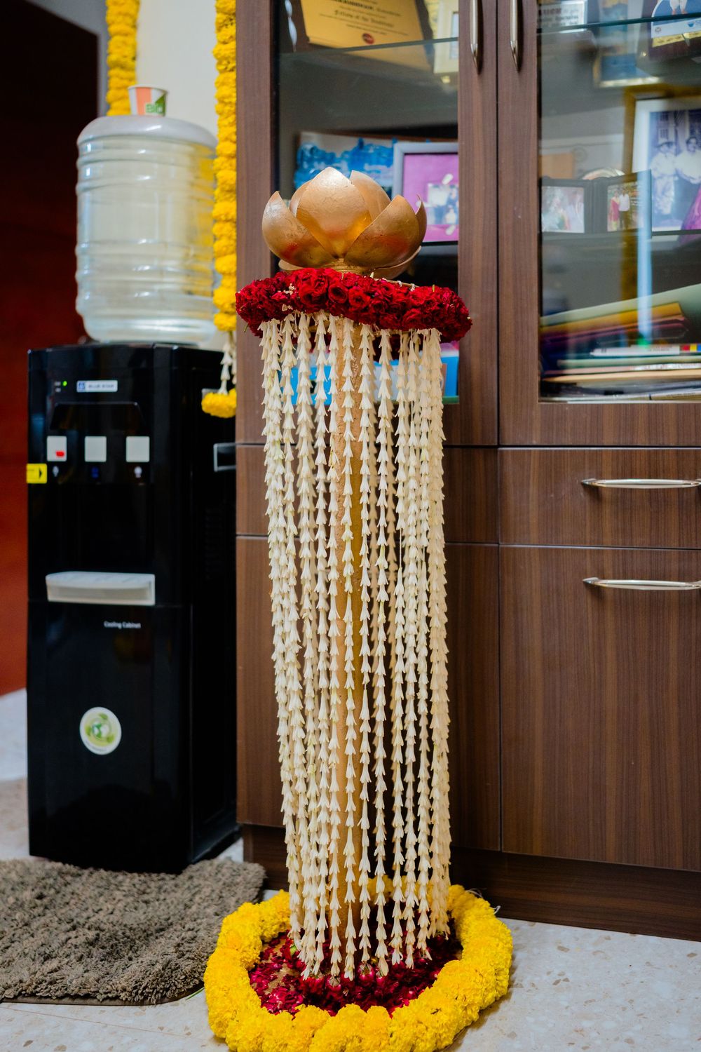 Traditional Indian jasmine garland decoration with golden lotus top and marigold base for wedding ceremony.