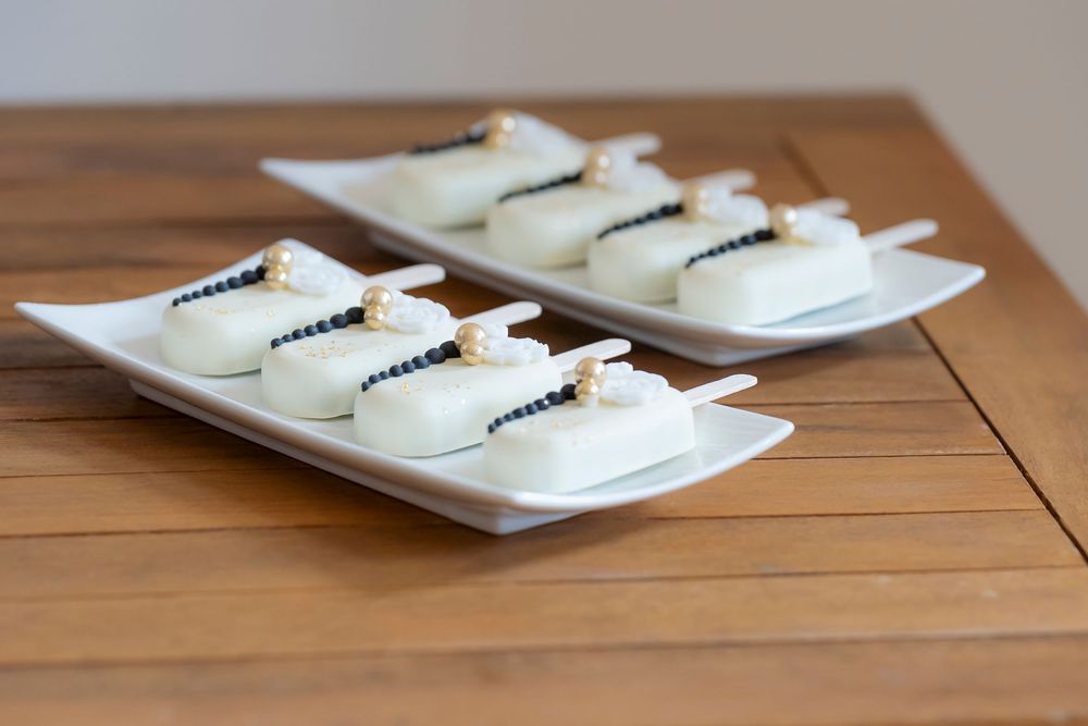 White ceramic plates arranged on wooden table for wedding reception.