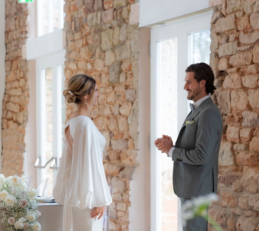 Wedding first look sequence showing couple's reactions in stone-walled venue.
