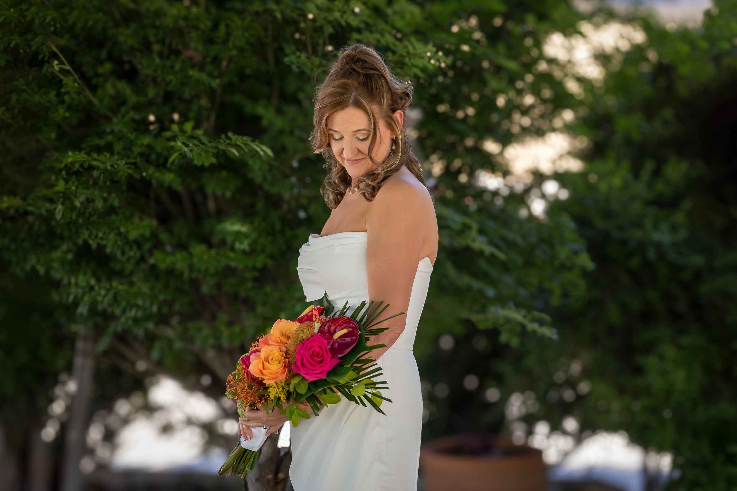 backyard wedding Boise Idaho Milestones Portraits Bride looking at flowers